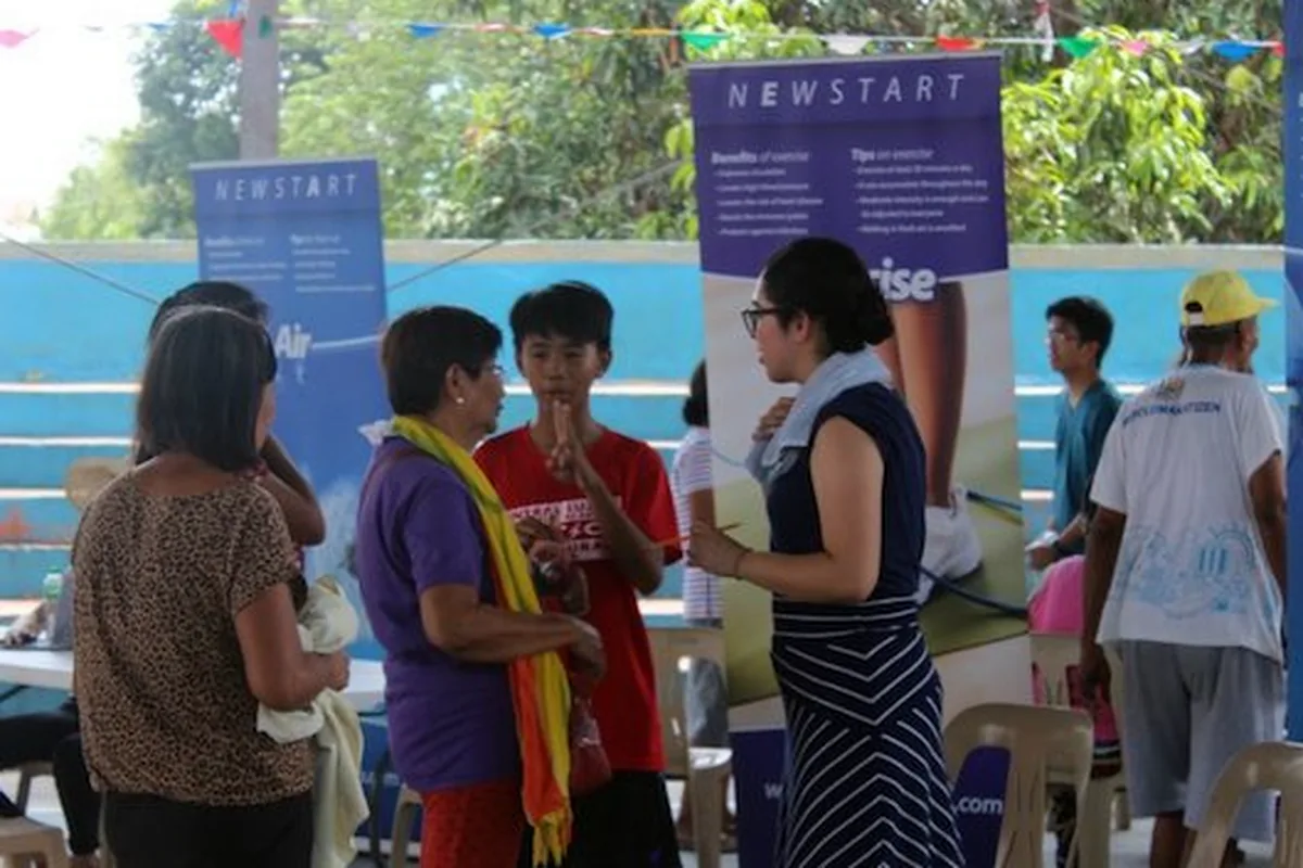 PNCE volunteers staffing a NEWSTART health outreach booth